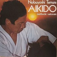 Cover of Aïkido – Méthode nationale: Tamura in a white keikogi, title in white and orange